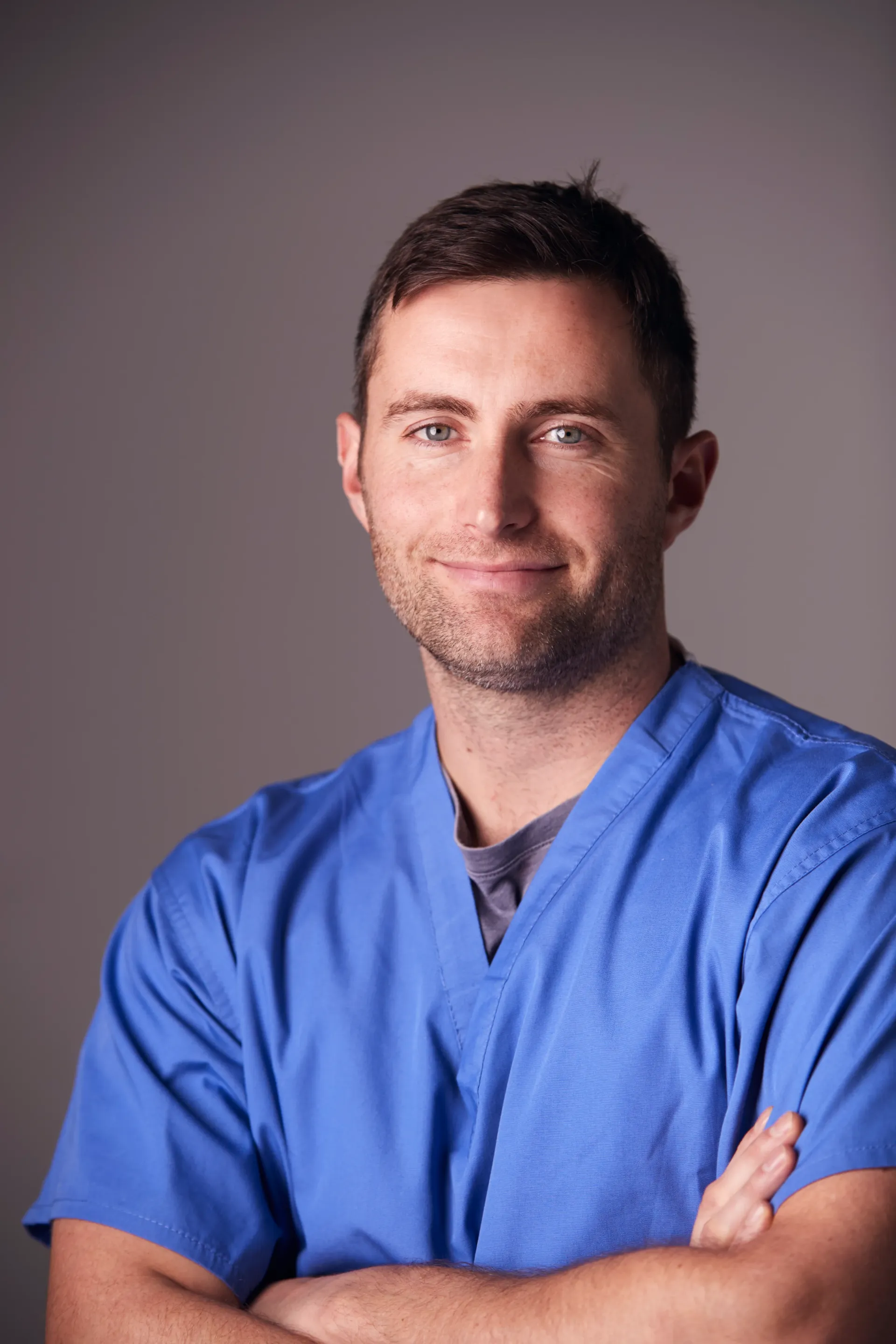 studio-portrait-of-male-nurse-wearing-scrubs-stand-2024-10-20-06-10-56-utc.webp